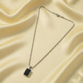 Side view of men's durable stainless-steel pendant chain with black pendant