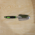 Garden tool in use for planting in flower bed