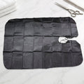 Professional hair cutting apron cape hanging on hook
