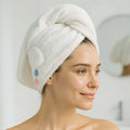 Hair drying towel cap in use, showing compact travel-friendly design