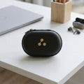 Front view of the compact portable case for wireless earbuds.