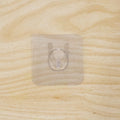Wall hook on wooden door with transparent adhesive