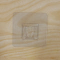 Pack of multiple transparent self-adhesive wall hooks.