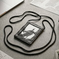 Close-up of the black PU leather neck wallet showing the clear ID window
