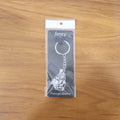 Lifestyle image of silver finish Bal Krishna keychain attached to car keys