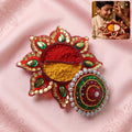 Front view of a handcrafted kumkum holder with traditional design.
