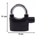 Hand holding the Security Alarm Padlock, showing its size and ergonomic grip.