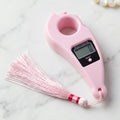 Close-up of pink digital mantra jaap counter with button and LCD screen pooja accessories