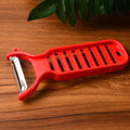 Dual-function grater and peeler tool by Supermom for fresh ginger