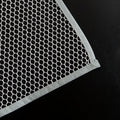 Hand holding the lightweight Large Ironing Press Net mesh protector cloth