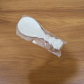 Rice serving spoon placed in kitchen setting with other utensils