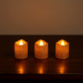 Safe flameless LED tealight candles with glitter finish on shelf