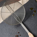 Oil draining skimmer spoon for safe frying and cooking