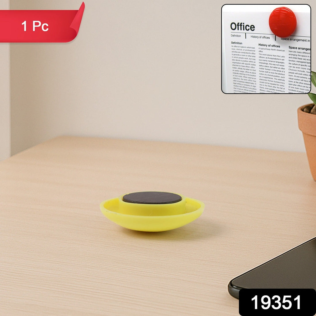 Yellow circular magnetic button gripping whiteboard surface