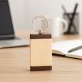 Top view of wooden keychain with dual-tone finish and metal ring