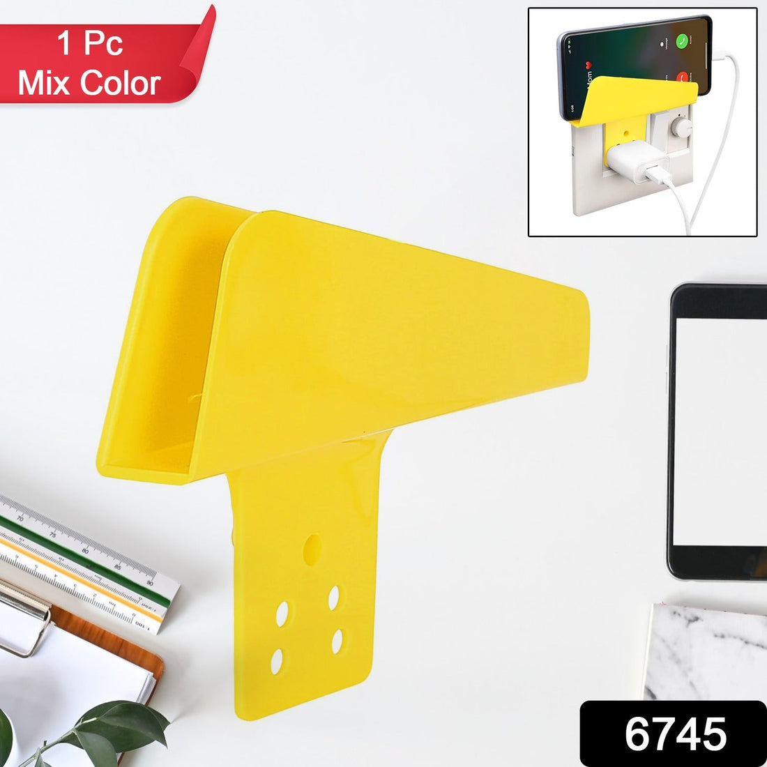 Gambit Mobile Charging Stand securely holding a smartphone while plugged into a wall socket.