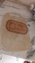 Hand holding lightweight plastic chopping board with handle