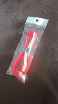 Two parts of the glove clip holder, highlighting its safety breakaway feature.