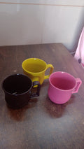 An empty plastic coffee mug ready for use, showcasing its sturdy base and comfortable grip.