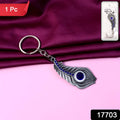 Close view of crystal adorned peacock feather keychain in metal